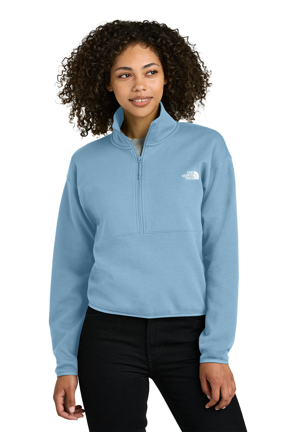 Woman wearing a light blue pullover with a brand logo on a white background embroidered The North Face® Women's Double-Knit 1/2-Zip Fleece