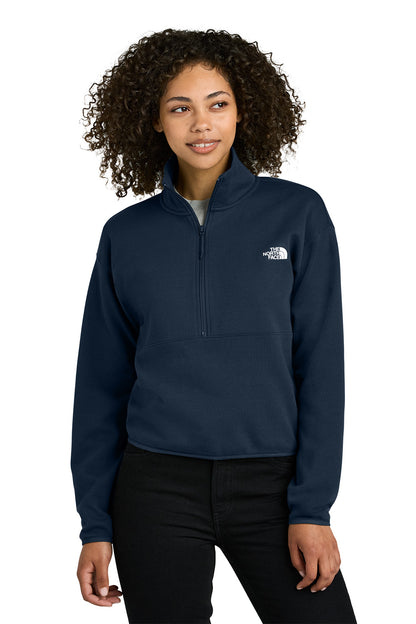 Woman wearing a navy blue pullover with a logo on a white background embroidered The North Face® Women's Double-Knit 1/2-Zip Fleece
