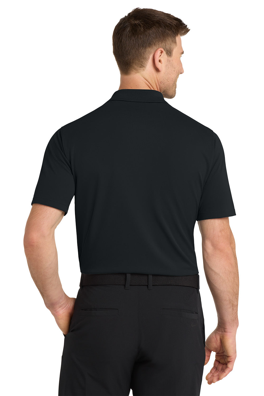 Man wearing a black polo shirt and pants on a white background. Nike Dri-FIT Micro Pique 2.0 Polo, Embroidered by Helmsman Stitch Co.