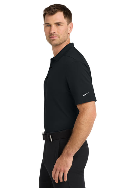 Man wearing a black Nike polo shirt on a white background. Nike Dri-FIT Micro Pique 2.0 Polo, Embroidered by Helmsman Stitch Co.