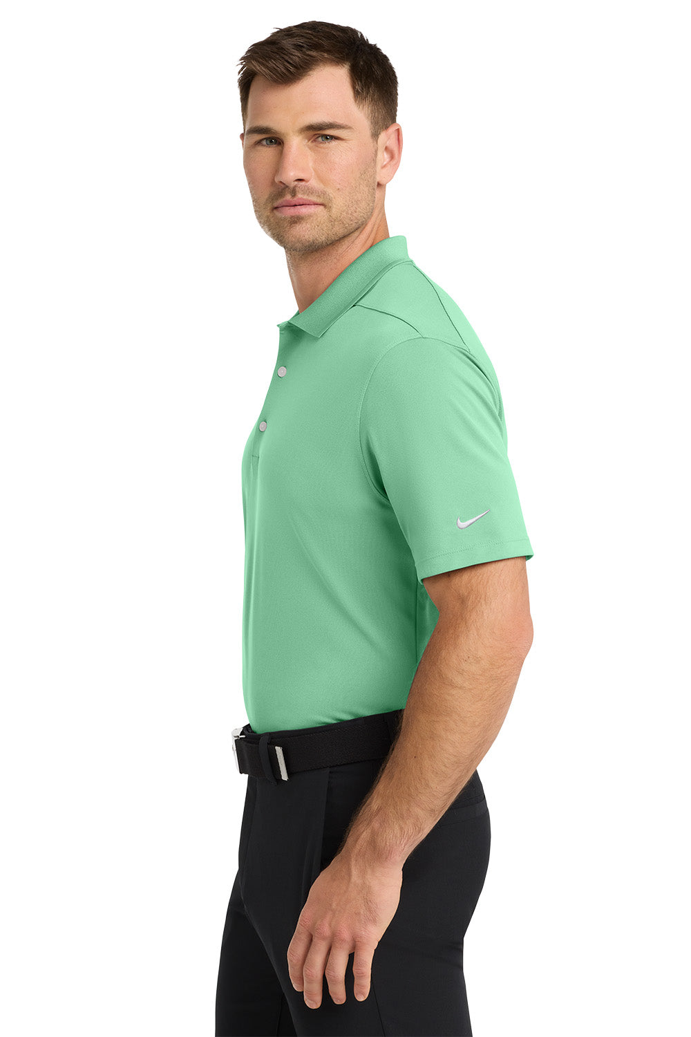 Man wearing a green Nike polo shirt on a white background. Nike Dri-FIT Micro Pique 2.0 Polo, Embroidered by Helmsman Stitch Co.