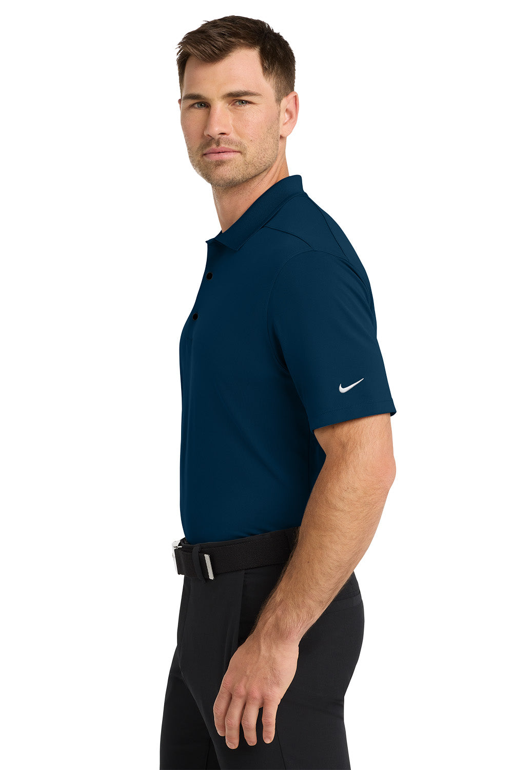 Man wearing a navy blue Nike polo shirt on a white background. Nike Dri-FIT Micro Pique 2.0 Polo, Embroidered by Helmsman Stitch Co.