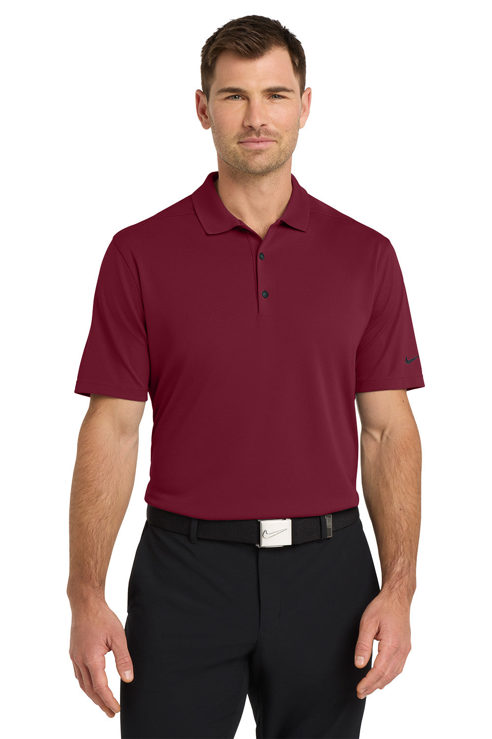 Man wearing a maroon polo shirt and black pants on a white background. Nike Dri-FIT Micro Pique 2.0 Polo, Embroidered by Helmsman Stitch Co.