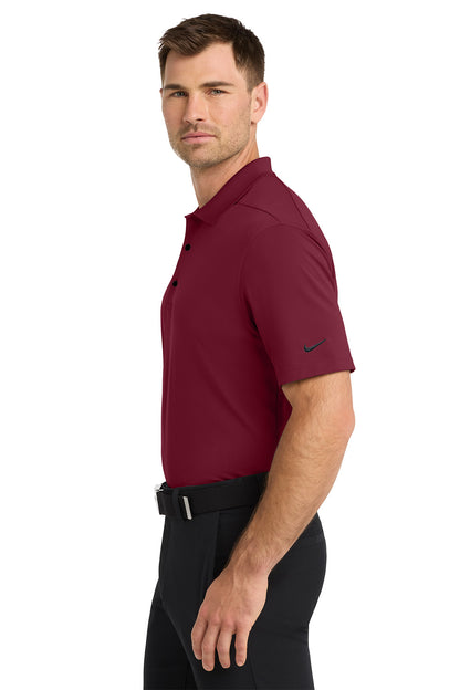 Man wearing a maroon Nike polo shirt on a white background. Nike Dri-FIT Micro Pique 2.0 Polo, Embroidered by Helmsman Stitch Co.