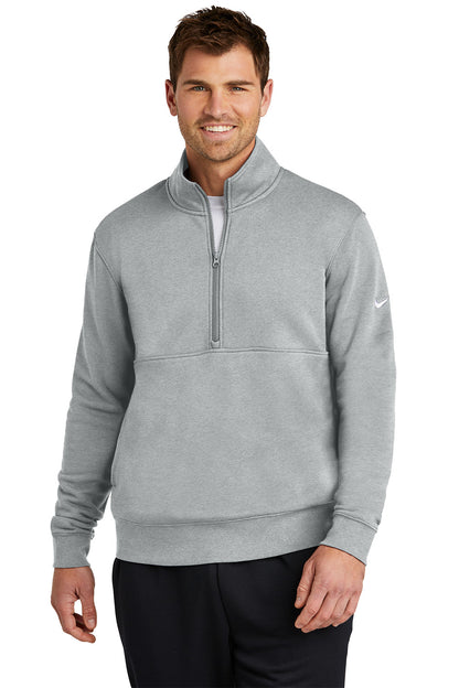 Man wearing a gray Nike half-zip pullover on a white background, Embroidered Nike Club Fleece Sleeve Swoosh 1/2-Zip