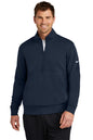 Man wearing a navy blue Nike half-zip pullover on a white background, Embroidered Nike Club Fleece Sleeve Swoosh 1/2-Zip