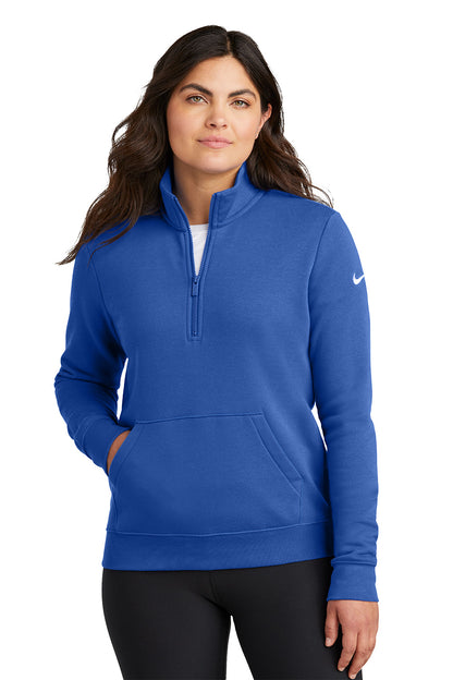 Woman wearing a blue Nike pullover on a white background, Embroidered Nike Women's Club Fleece Sleeve Swoosh 1/2-Zip