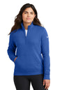 Woman wearing a blue Nike pullover on a white background, Embroidered Nike Women's Club Fleece Sleeve Swoosh 1/2-Zip