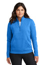 Woman wearing a blue Nike pullover on a white background, Embroidered Nike Women's Club Fleece Sleeve Swoosh 1/2-Zip