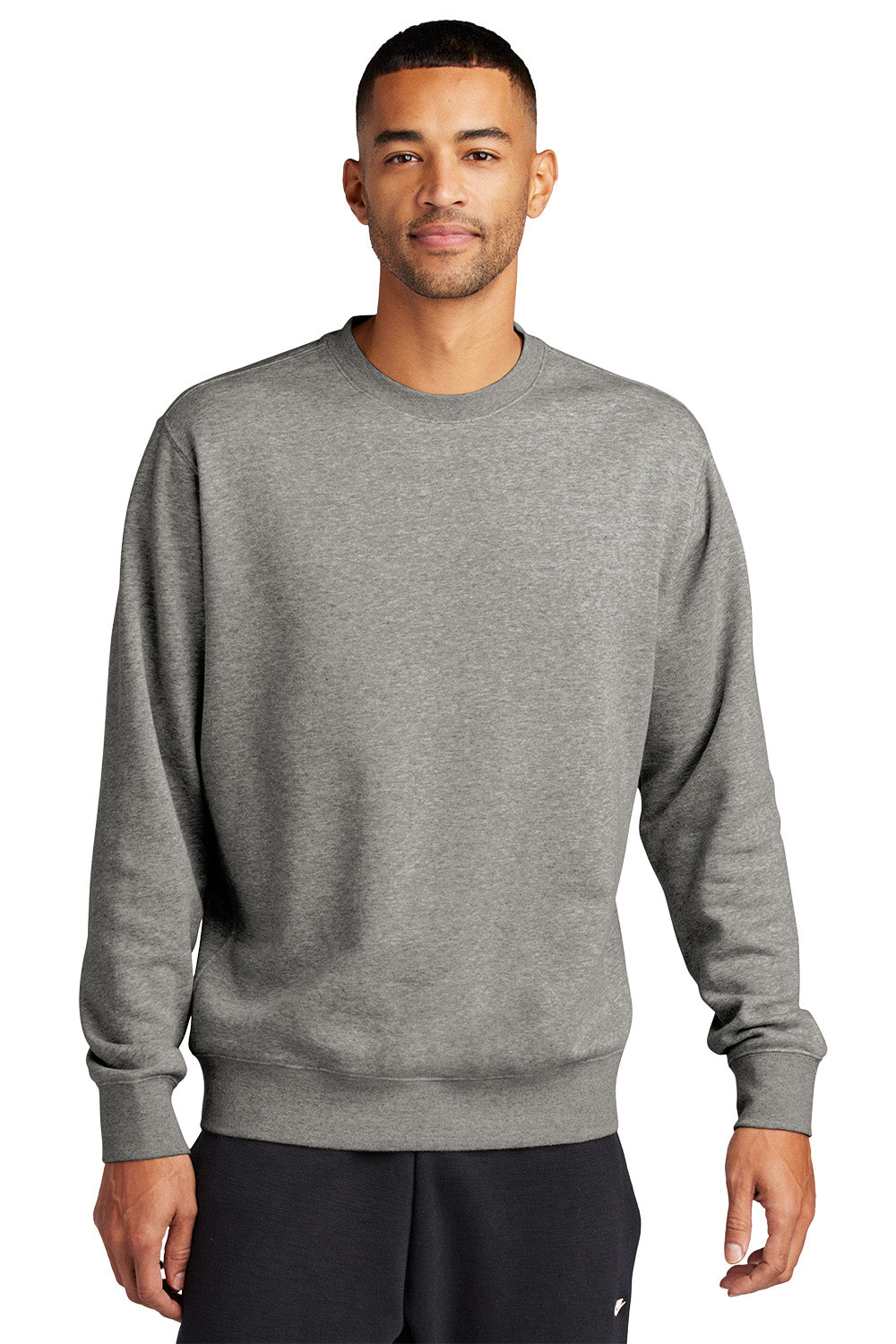 Man wearing a gray sweatshirt on a white background embroidered Nike Club Fleece Sleeve Swoosh Crew