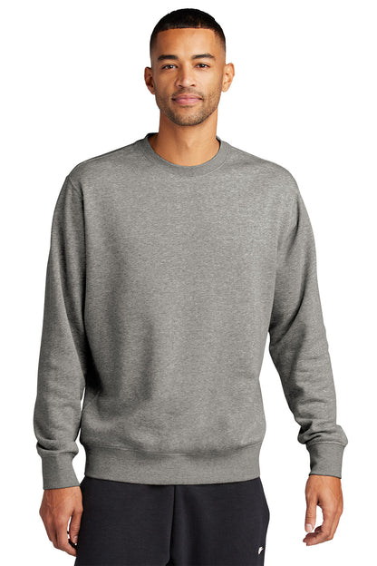 Man wearing a gray sweatshirt on a white background embroidered Nike Club Fleece Sleeve Swoosh Crew