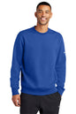 Man wearing a blue Nike sweatshirt on a white background embroidered Nike Club Fleece Sleeve Swoosh Crew