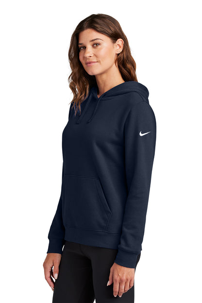 Woman wearing a navy blue hoodie with a Nike logo on a white background, Embroidered Nike Women's Club Fleece Sleeve Swoosh Hoodie