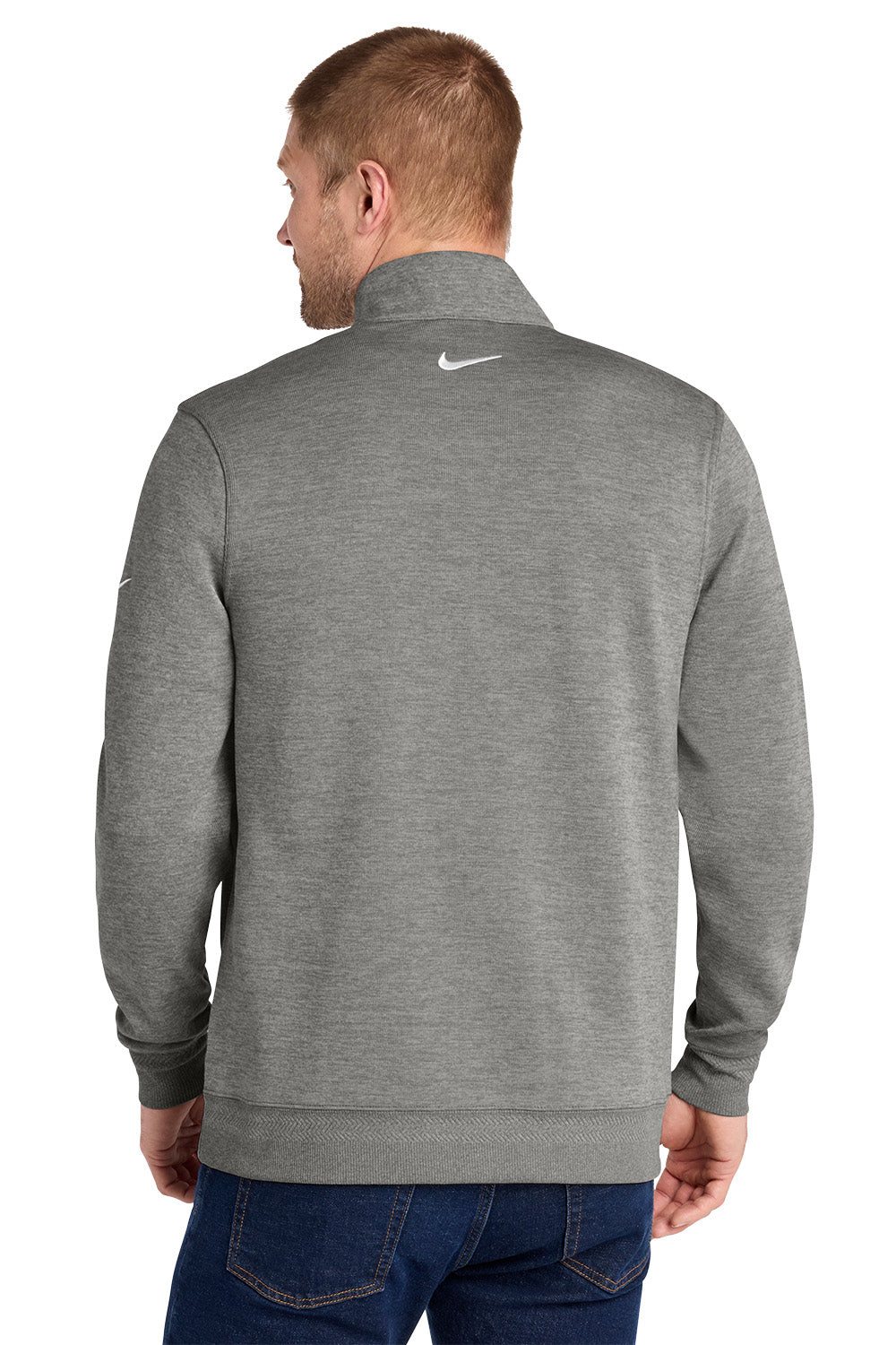 A man viewed from the back wearing a heather gray Nike quarter-zip pullover sweatshirt and blue jeans, set against a plain white background. Nike Dri-FIT Corporate 1/2-Zip, Embroidered