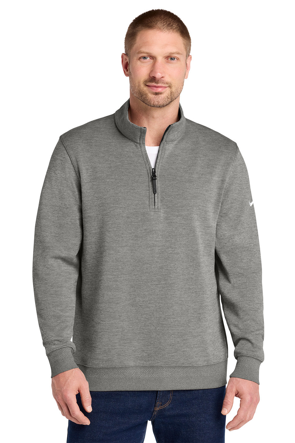 A man wearing a heather gray quarter-zip pullover sweatshirt with a mock neck, paired with dark blue jeans, photographed against a solid white background. Nike Dri-FIT Corporate 1/2-Zip, Embroidered