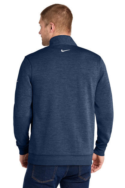 A man viewed from the back wearing a navy blue heathered quarter-zip pullover sweatshirt with a white Nike swoosh on the upper back, paired with dark blue jeans against a plain white background. Nike Dri-FIT Corporate 1/2-Zip, Embroidered