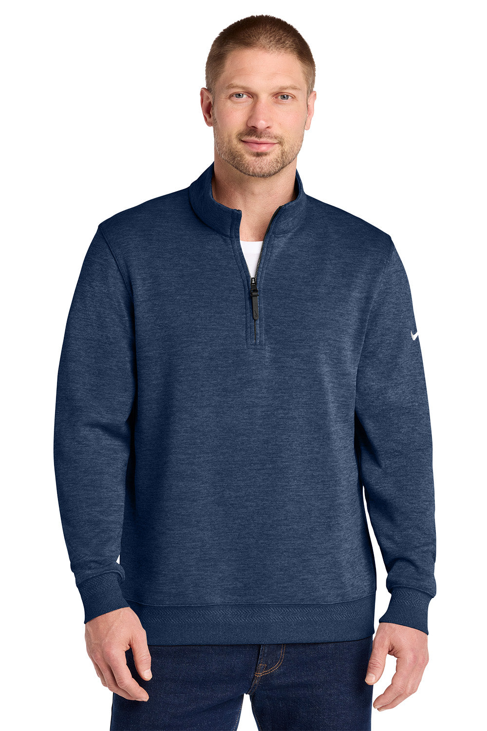 A man wearing a navy blue heathered quarter-zip pullover sweatshirt with a small white Nike swoosh on the left sleeve, paired with dark blue jeans, against a plain white background. Nike Dri-FIT Corporate 1/2-Zip, Embroidered