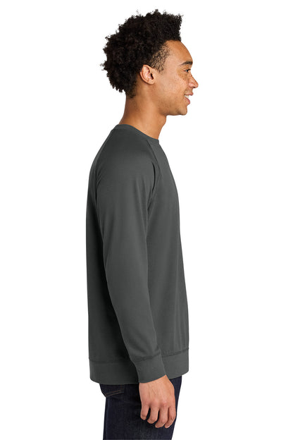 Person wearing a dark gray long-sleeve shirt on a white background. Next Level Apparel® Laguna Raglan Sweatshirt, Embroidered