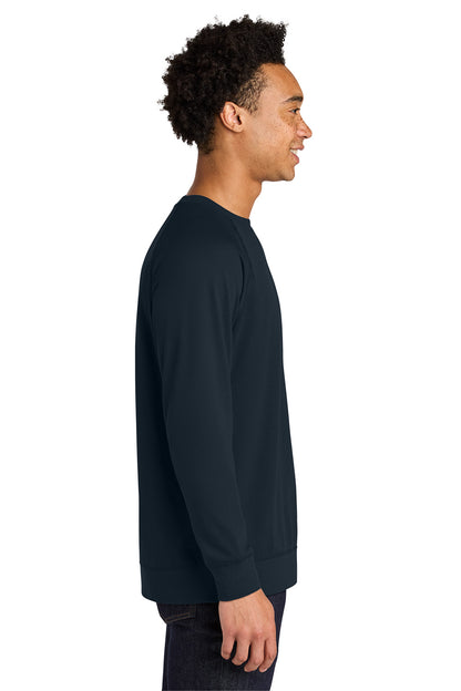 A man shown in side profile wearing a dark navy long-sleeve crewneck sweatshirt against a plain white background. Next Level Apparel® Laguna Raglan Sweatshirt, Embroidered