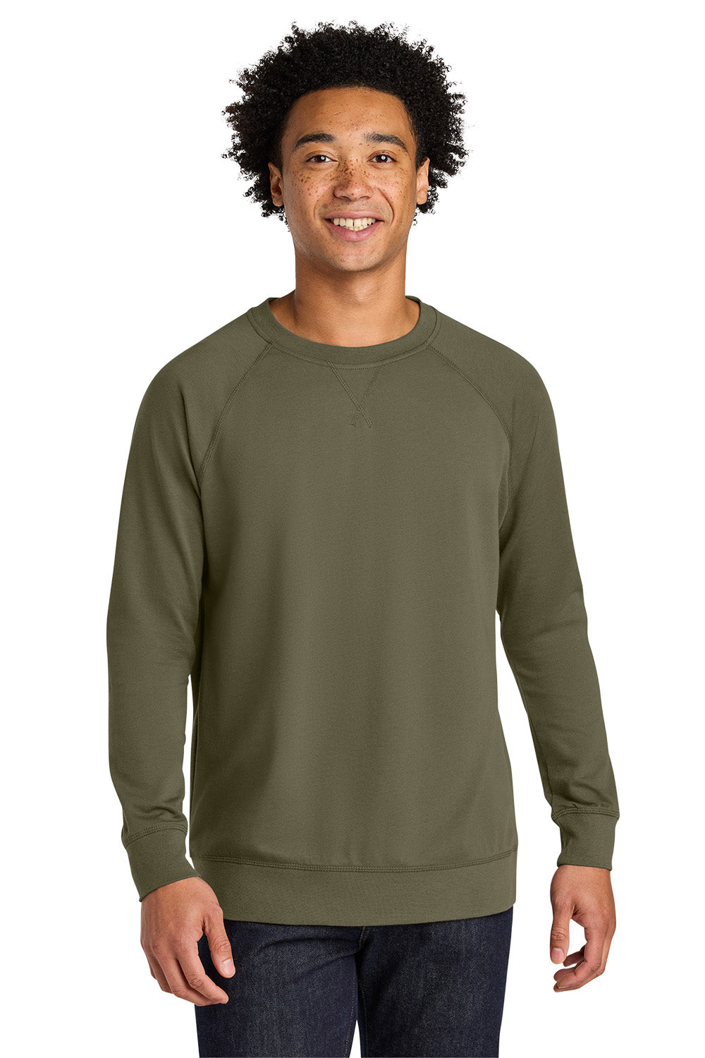 A man wearing an olive green long-sleeve crewneck sweatshirt, paired with dark blue jeans, standing against a plain white background. Next Level Apparel® Laguna Raglan Sweatshirt, Embroidered