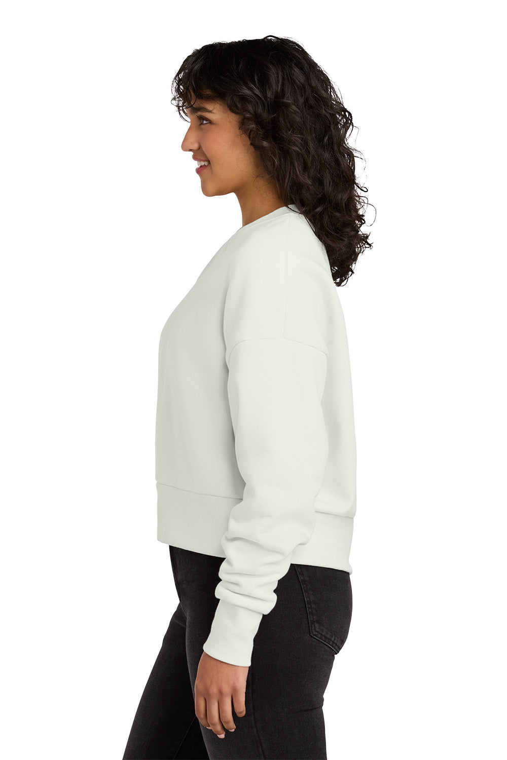 Woman wearing a white sweater and black pants on a white background. Next Level Apparel® Women’s Heavyweight Sweatshirt, Embroidered