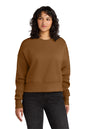 Woman wearing a brown sweatshirt and black pants on a white background. Next Level Apparel® Women’s Heavyweight Sweatshirt, Embroidered