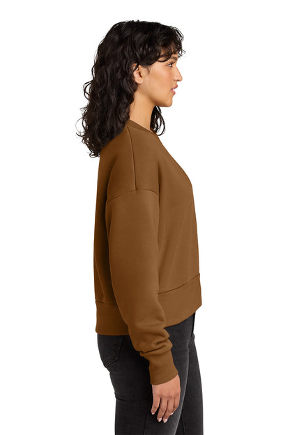 Woman wearing a brown sweatshirt on a white background. Next Level Apparel® Women’s Heavyweight Sweatshirt, Embroidered