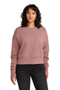 Woman wearing a pink sweatshirt and black pants on a white background. Next Level Apparel® Women’s Heavyweight Sweatshirt, Embroidered
