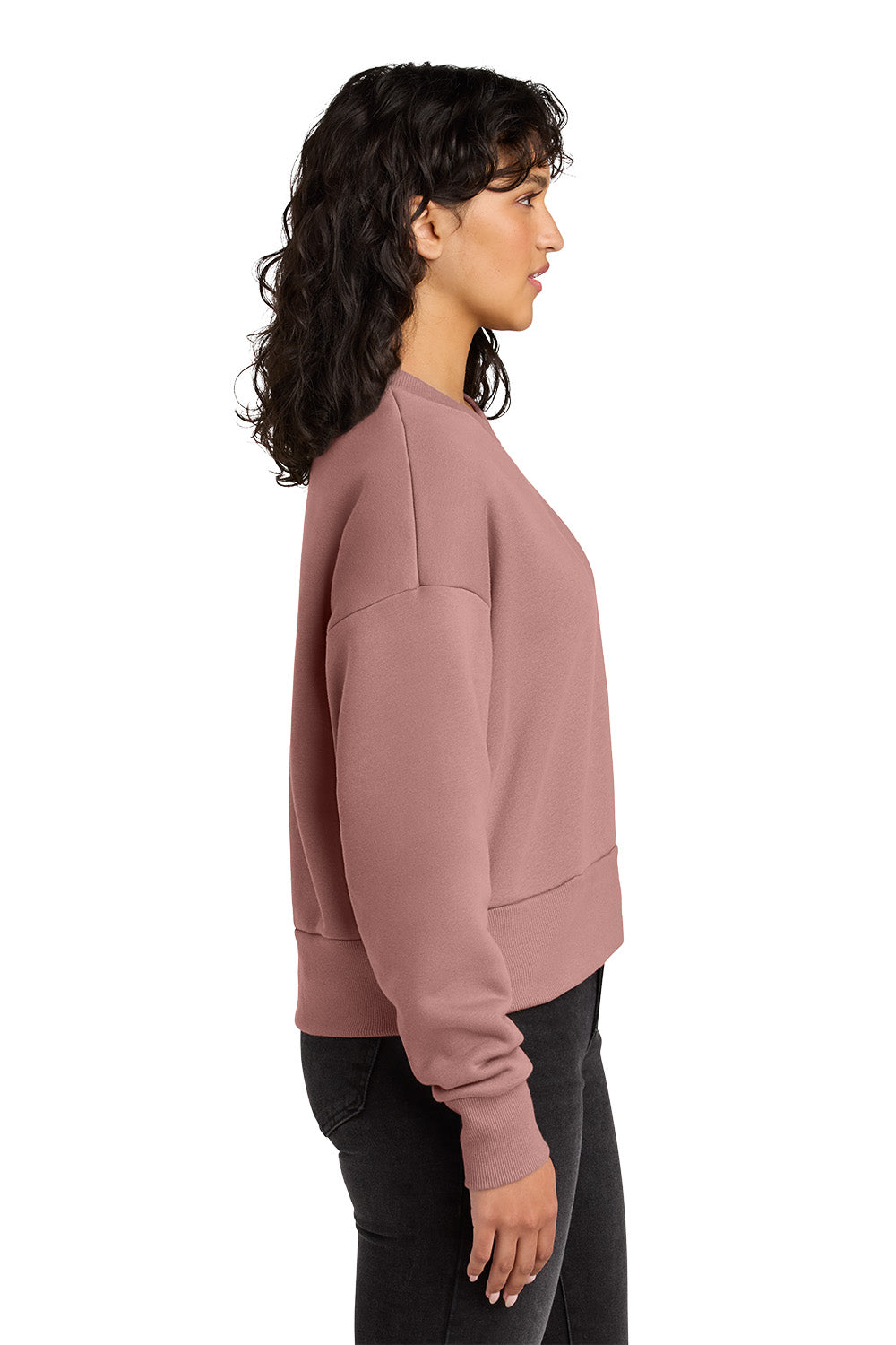 Woman wearing a pink sweatshirt on a white background. Next Level Apparel® Women’s Heavyweight Sweatshirt, Embroidered