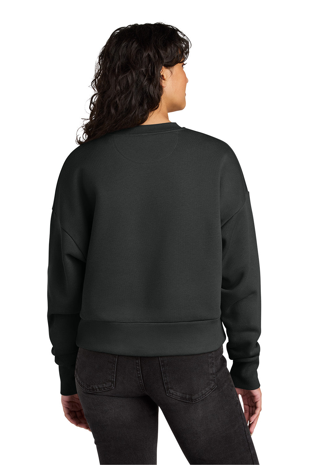 A woman viewed from the back wearing a dark charcoal gray crewneck sweatshirt and dark jeans against a plain white background. Next Level Apparel® Women’s Heavyweight Sweatshirt, Embroidered