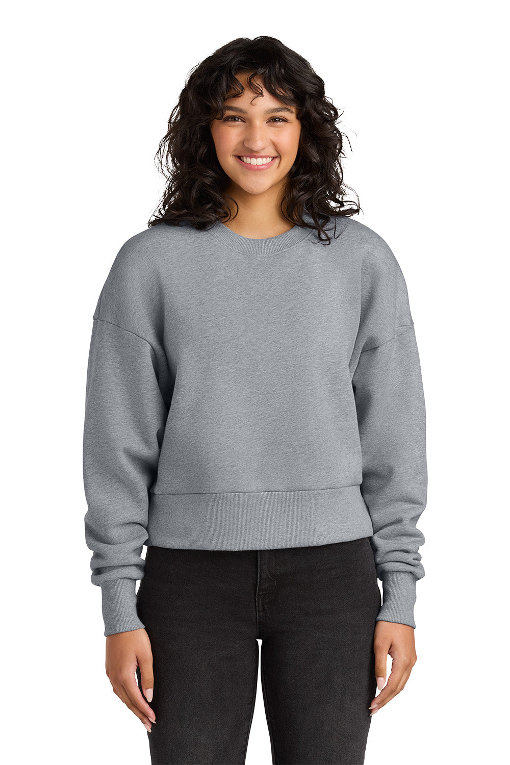 Person wearing a gray sweatshirt and black pants on a white background. Next Level Apparel® Women’s Heavyweight Sweatshirt, Embroidered