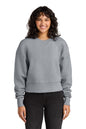 Person wearing a gray sweatshirt and black pants on a white background. Next Level Apparel® Women’s Heavyweight Sweatshirt, Embroidered