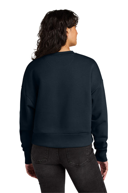 Person wearing a navy blue sweatshirt on a white background. Next Level Apparel® Women’s Heavyweight Sweatshirt, Embroidered