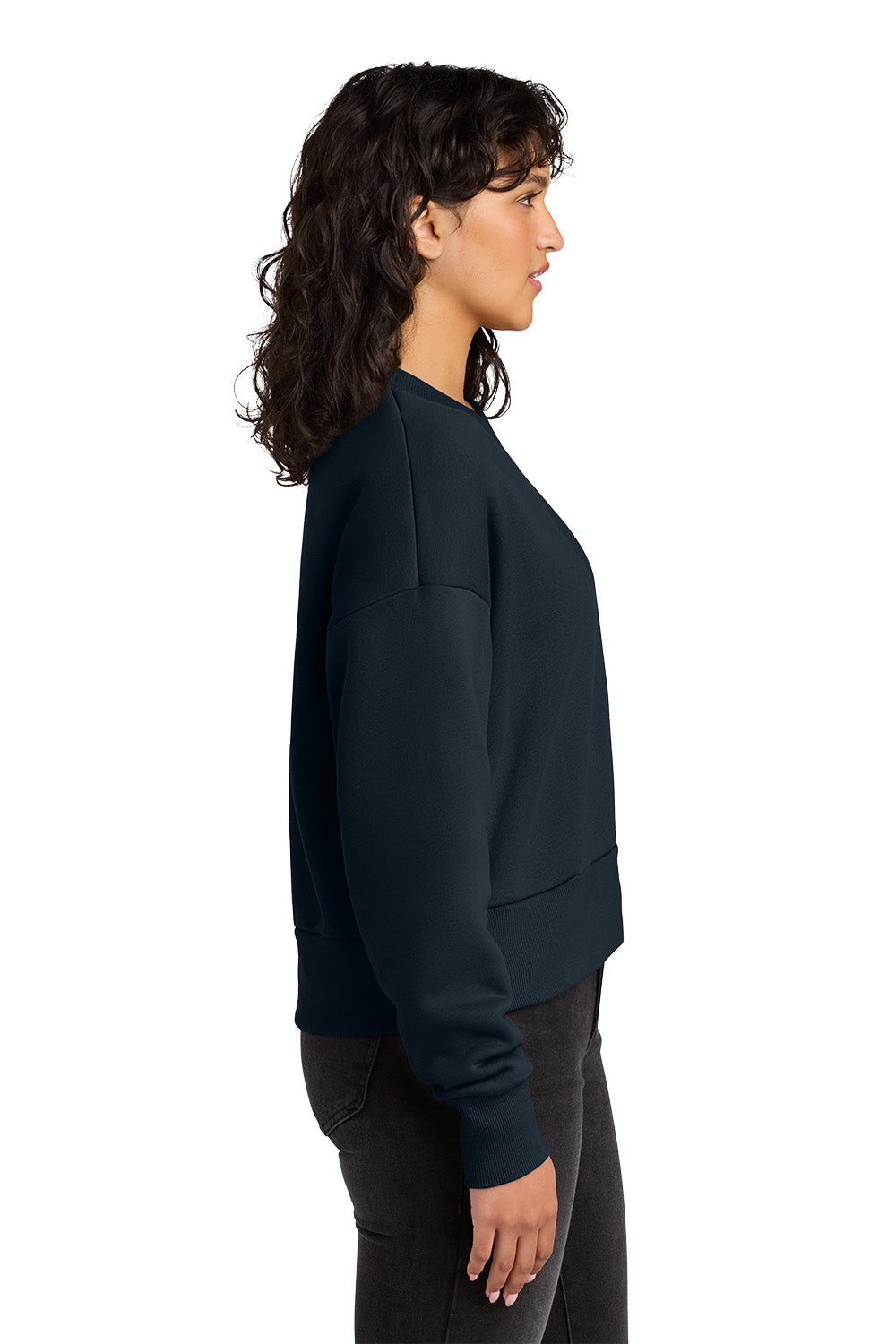 Woman wearing a dark blue sweatshirt on a white background. Next Level Apparel® Women’s Heavyweight Sweatshirt, Embroidered