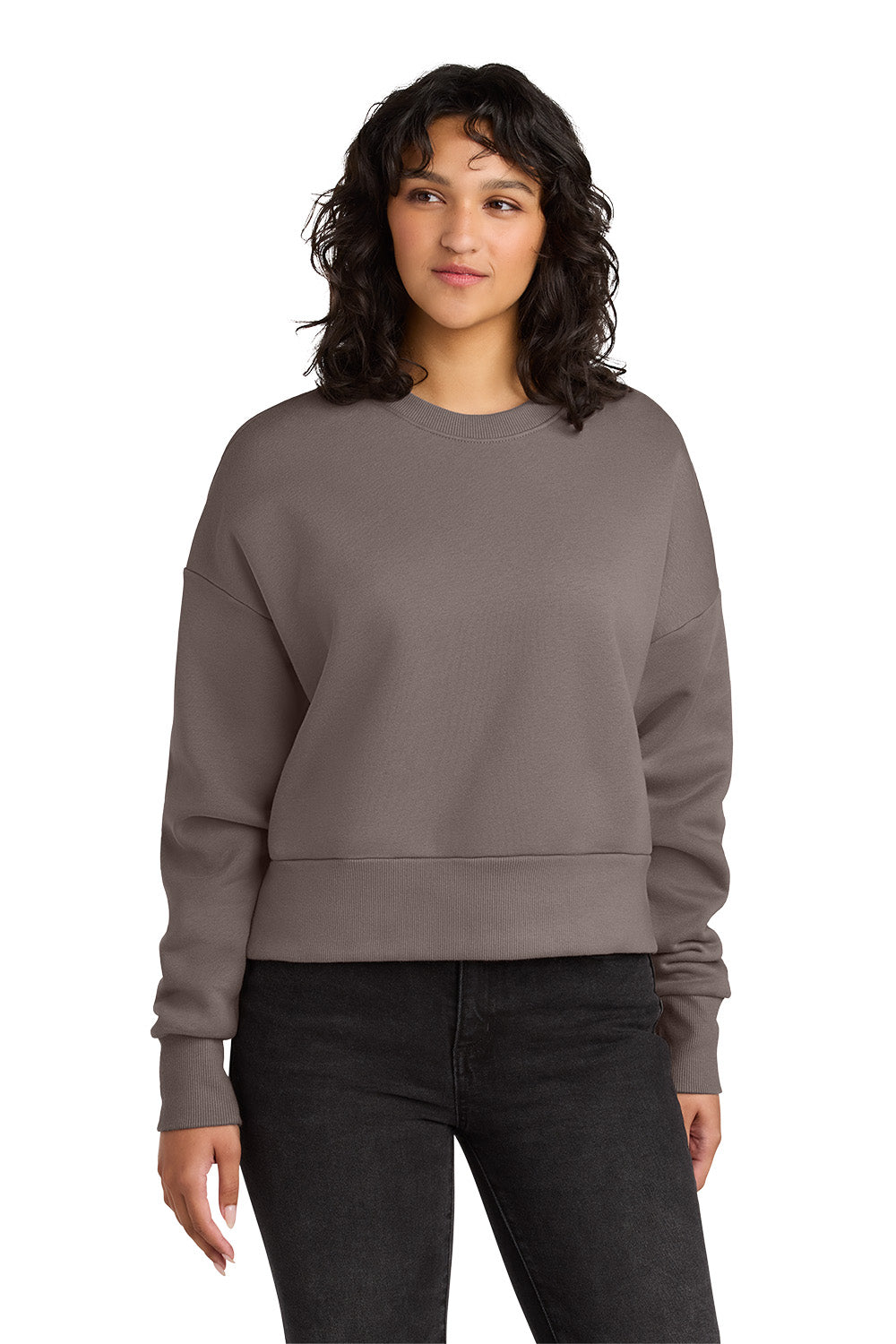 Woman wearing a gray sweatshirt and black pants on a white background. Next Level Apparel® Women’s Heavyweight Sweatshirt, Embroidered