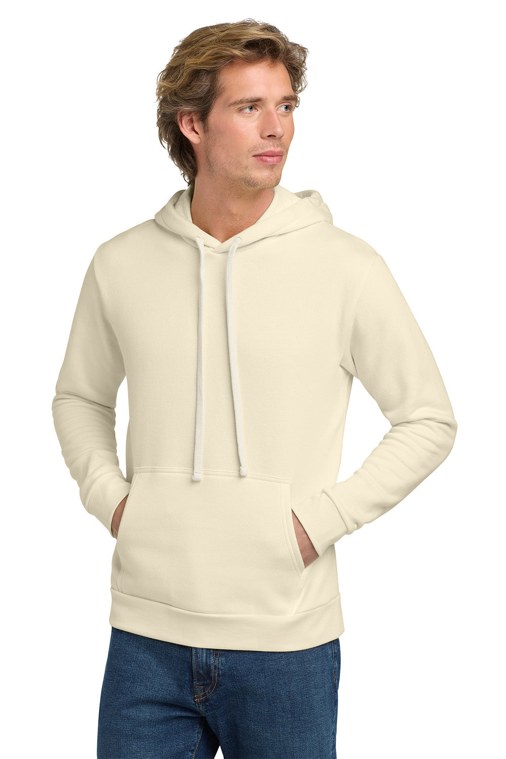 Man wearing a beige hoodie and blue jeans on a white background. Next Level Apparel® Adult Santa Barbara Pullover Hoodie, Embroidered
