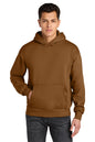 A man wearing a brown pullover hoodie with a kangaroo pocket, paired with dark gray jeans, photographed against a solid white background. Next Level Apparel® Heavyweight Hoodie, Embroidered