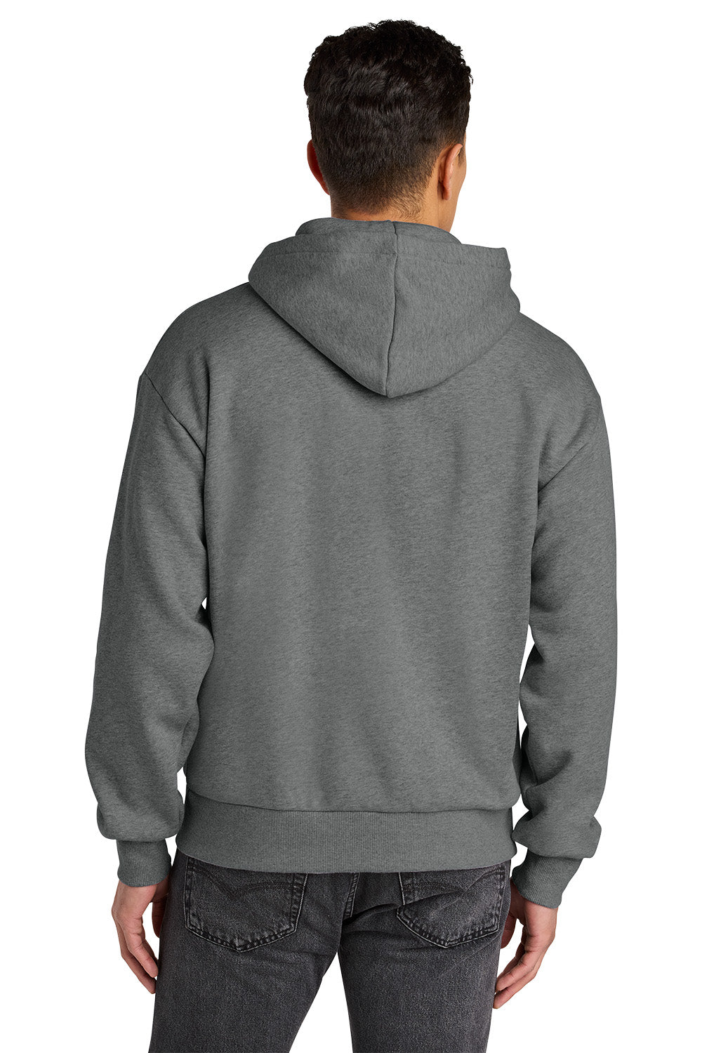 A man viewed from the back wearing a dark gray pullover hoodie and dark gray jeans against a plain white background. Next Level Apparel® Heavyweight Hoodie, Embroidered