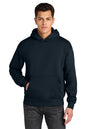 A man wearing a dark navy pullover hoodie with a front kangaroo pocket, paired with dark gray jeans, against a plain white background. Next Level Apparel® Heavyweight Hoodie, Embroidered