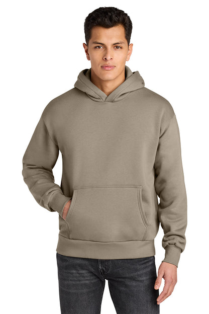 Man wearing a beige hoodie on a white background. Next Level Apparel® Heavyweight Hoodie, Embroidered