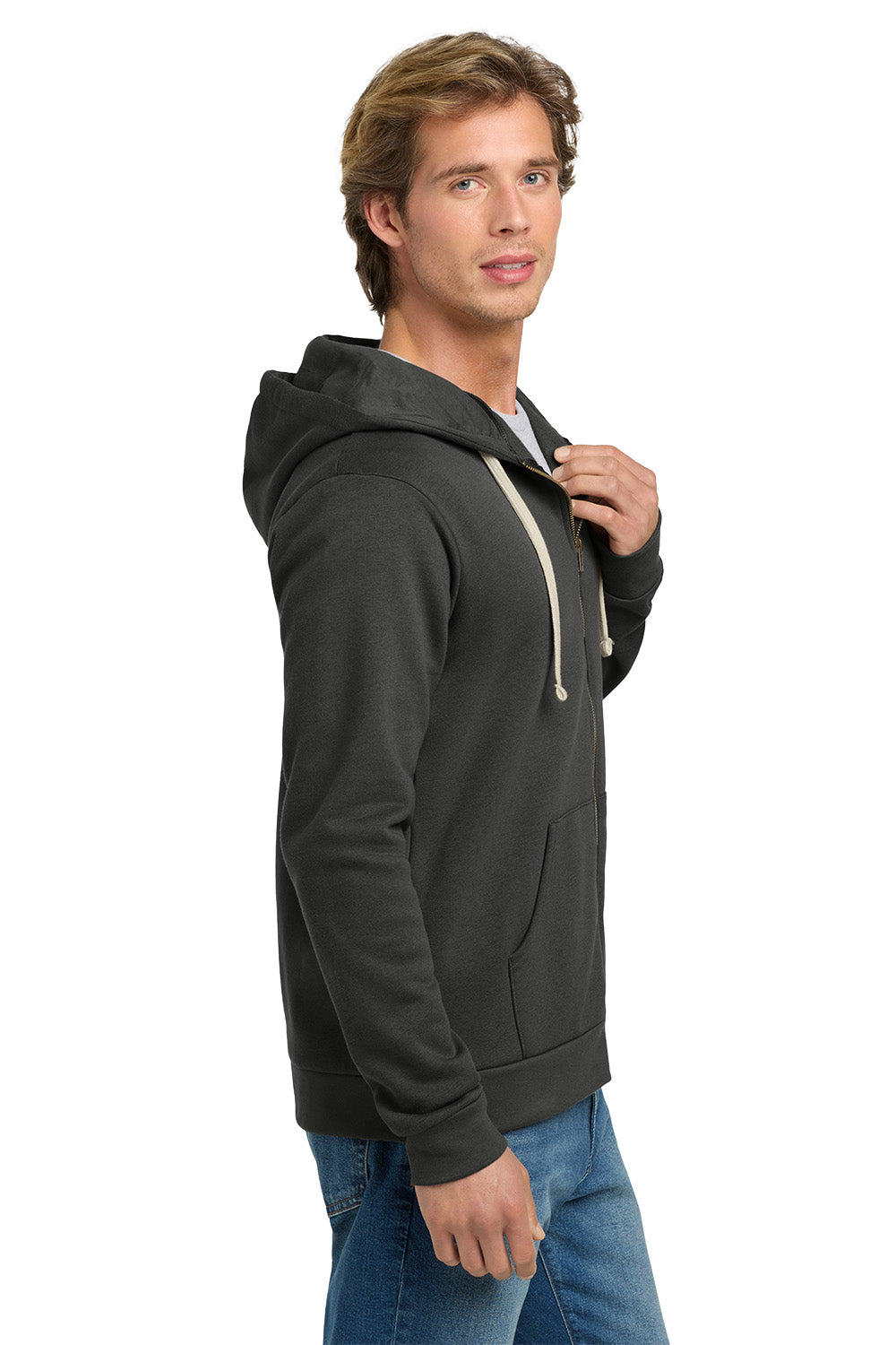 A man wearing a dark charcoal gray pullover hoodie with light beige drawstrings, paired with blue jeans, shown from a side profile against a white background. Next Level Apparel® Adult Santa Barbara Zip Hoodie, Embroidered