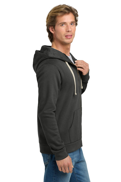 A man wearing a dark charcoal gray pullover hoodie with light beige drawstrings, paired with blue jeans, shown from a side profile against a white background. Next Level Apparel® Adult Santa Barbara Zip Hoodie, Embroidered