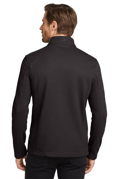 Man wearing a black ribbed long-sleeve shirt on a white background embroidered OGIO® Grit Fleece Jacket
