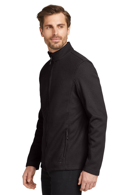 Man wearing a black jacket on a white background embroidered OGIO® Grit Fleece Jacket