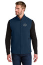 Man wearing a navy blue vest with customizable logo area on a white background, Embroidered OGIO® Kinetic Soft Shell Vest