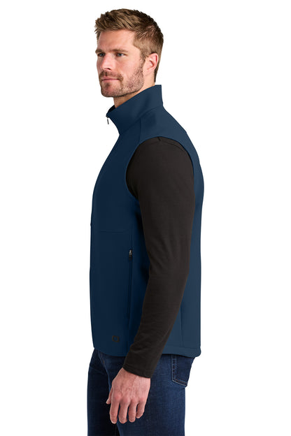 Man wearing a blue vest over a black shirt on a white background, Embroidered OGIO® Kinetic Soft Shell Vest