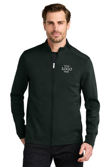 Man wearing a black jacket with customizable logo text on a white background OGIO® Transcend Full-Zip, Embroidered