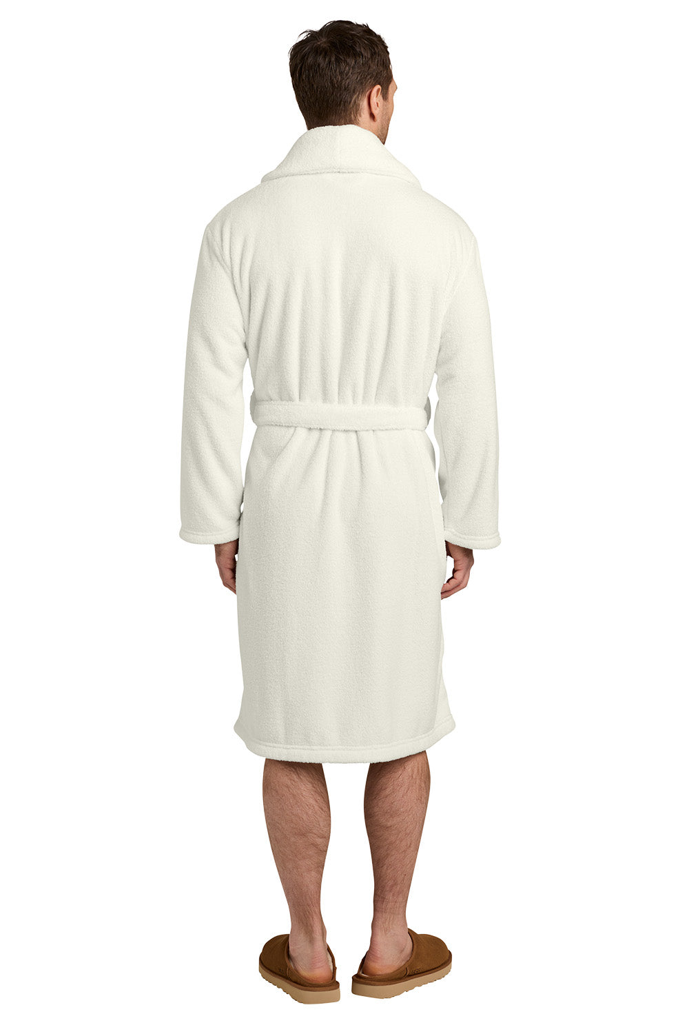 A man viewed from behind wearing a cream-colored plush bathrobe with a matching tie belt, paired with brown slippers against a plain white background. Port Authority® Dream Plush Robe, Embroidered