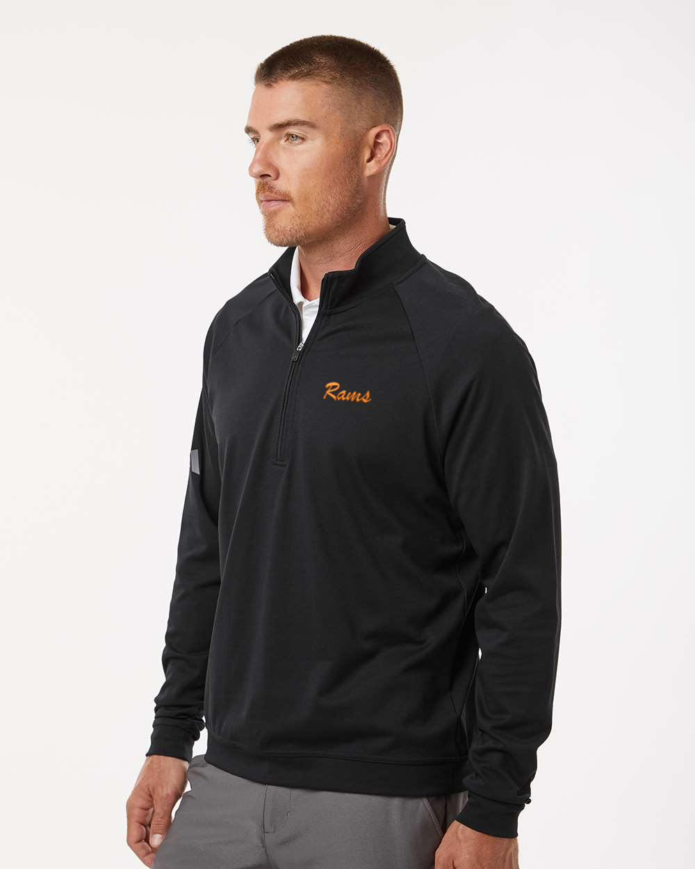 Man wearing a black quarter-zip pullover on a white background. Adidas Men's Club Quarter-Zip Pullover, RAM Logo by Helmsman Stitch Co.