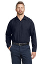Man wearing a navy button-up shirt and pants on a white background embroidered Red Kap® Long Sleeve Industrial Work Shirt